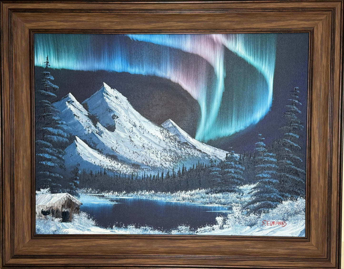 Oil painting on 18x24 canvas set within wood frame, Winter landscape with Northern lights, mountain, and cabin on a lake.